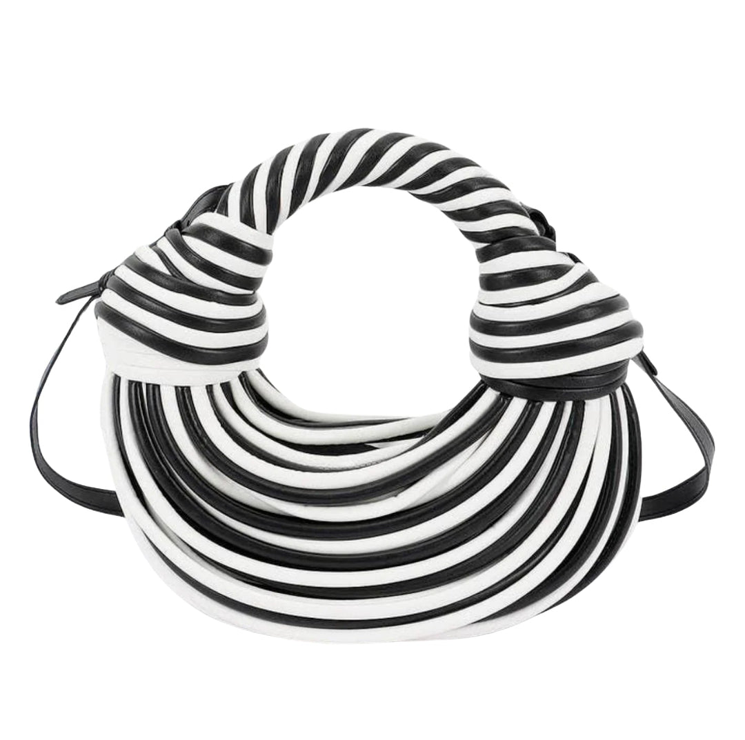 A black and white striped leather shoulder bag with a unique circular, knot-like silhouette and a thin black strap, shown on a plain white background.